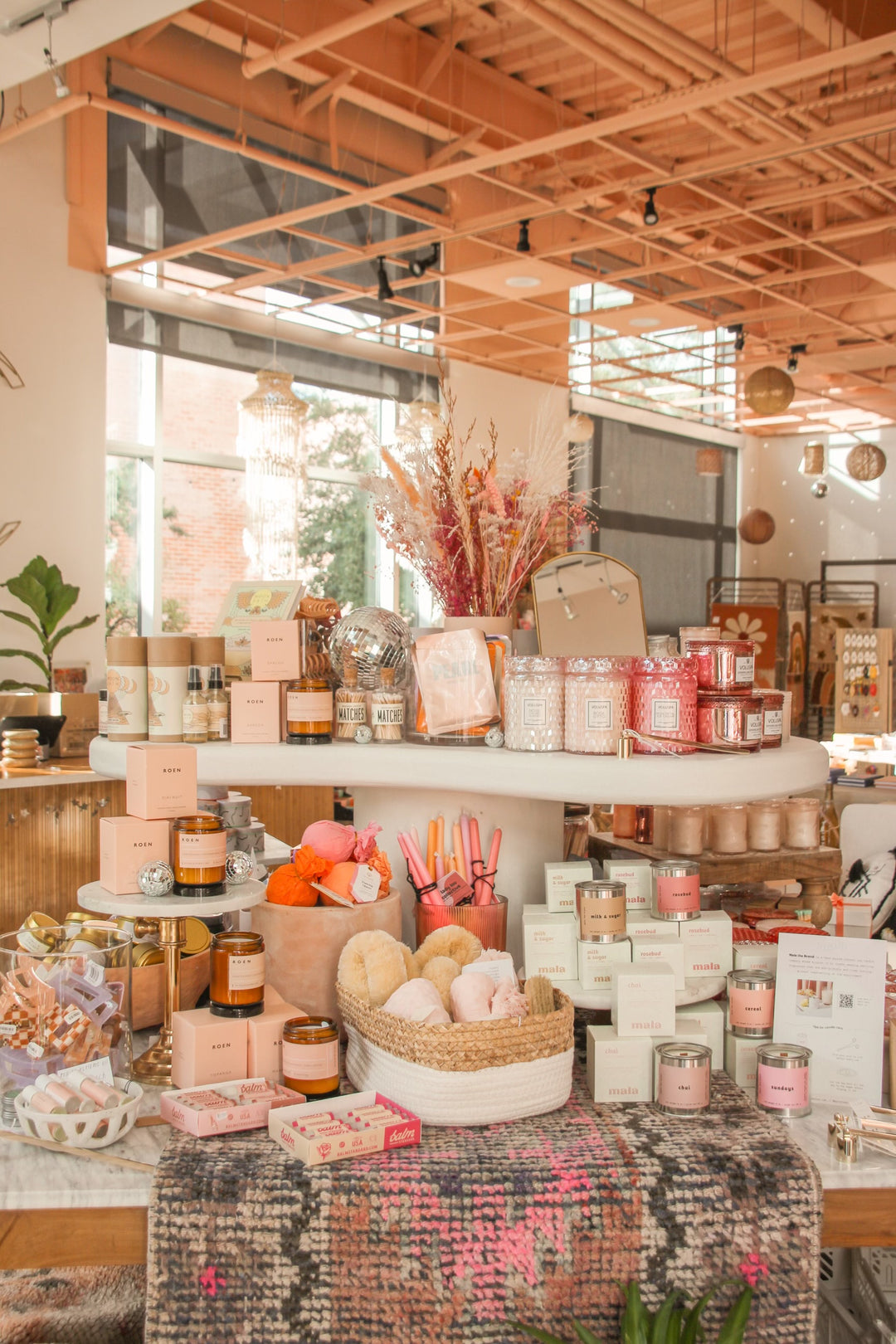 Mala Candles and Voluspa Candles on table at Pink Moon Mercantile