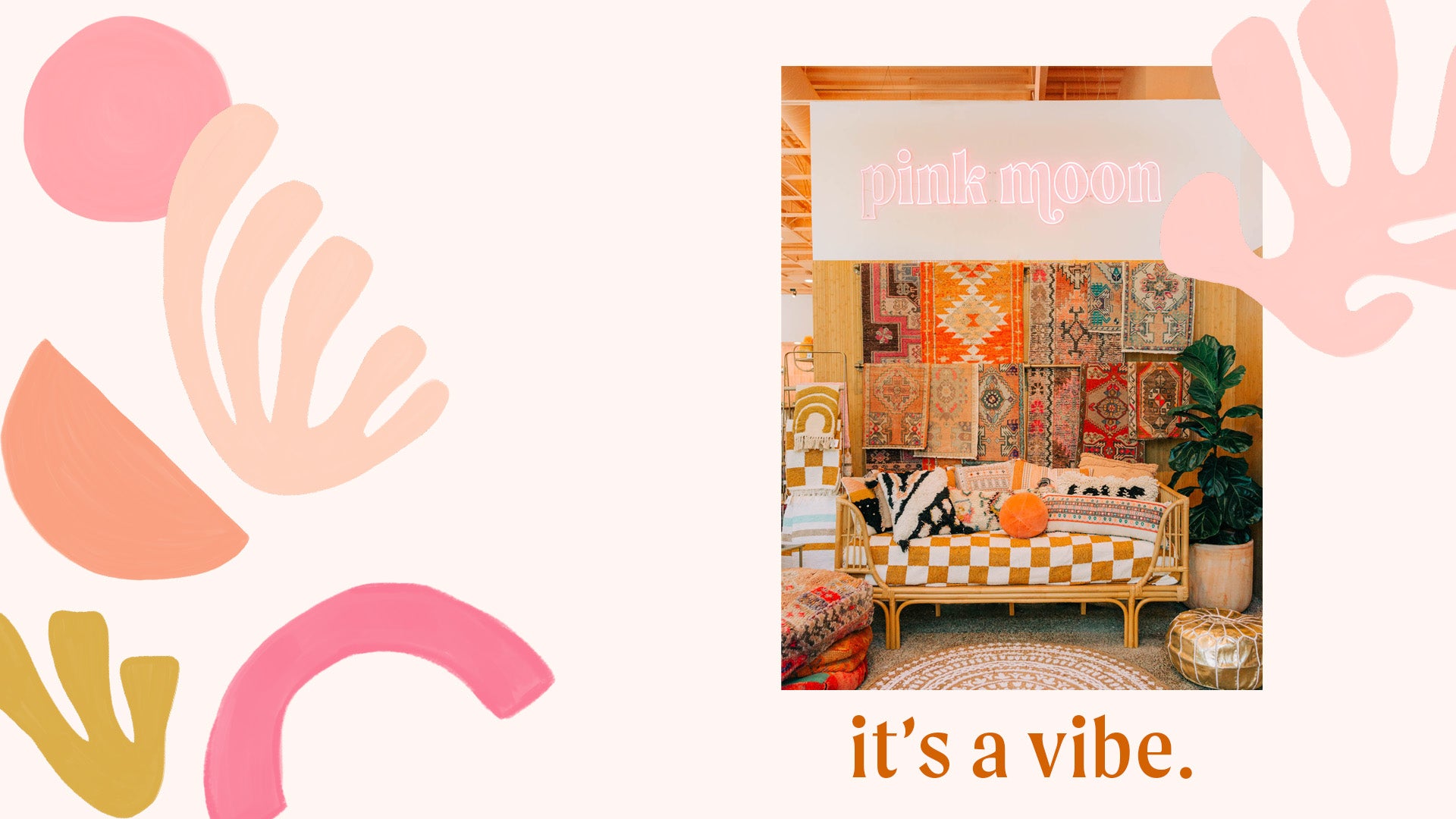 vintage moroccan rugs on a wall behind a couch with pillows at pink moon mercantile tucson arizona