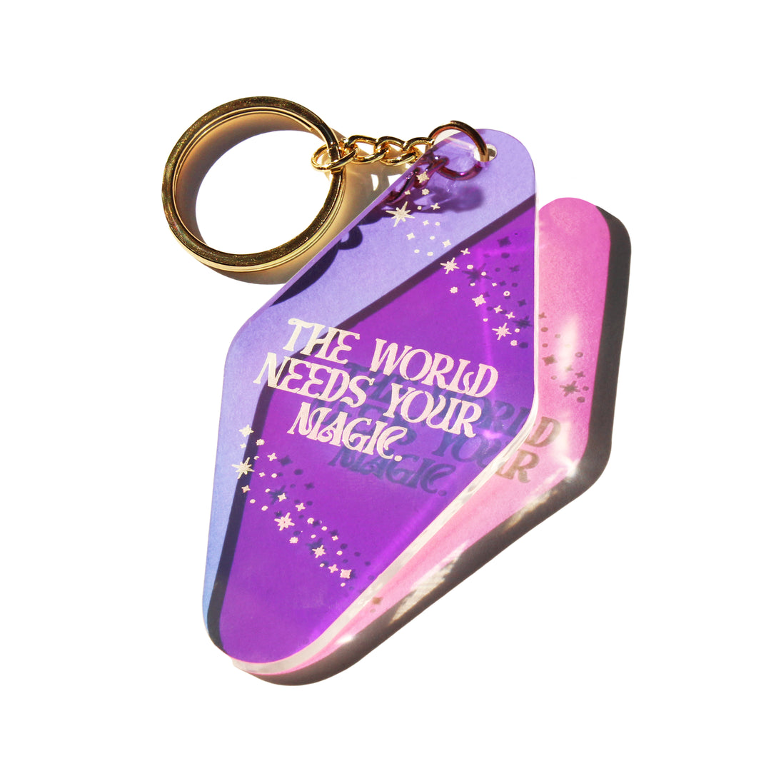 https://www.pinkmoonmercantile.com/cdn/shop/products/midniteminds-the-world-needs-your-magic-keychain-2.webp?v=1666621263&width=1080